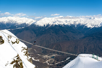 The bridge over the precipice on Rosa peak, 2320 meters surroundings Sochi Russia - April 14, 2023