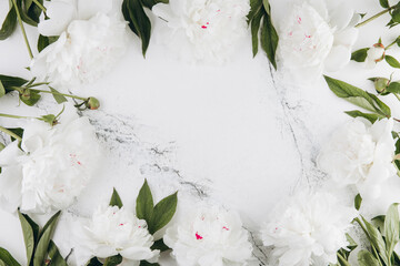 White peonies on a white marble background, copy space, flat lay, greeting card.
