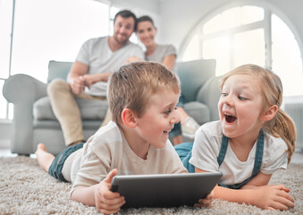 Our most basic instinct is for family. Shot of a little brother and sister using a digital tablet together at home.