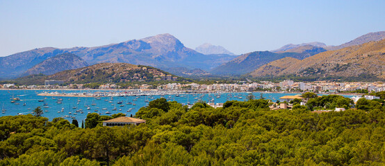 Fototapeta na wymiar Aerial view of the harbour of Port de Pollença, a seaside village located on the northern coast of Mallorca in the Balearic Islands, Spain