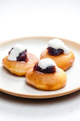 fried muffins with plum jam and sour cream