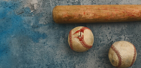 Old blue grunge texture background with used balls and wood bat.