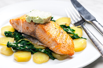 baked salmon with spinach leaves and potatoes