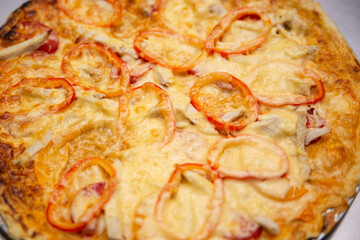 Pizza with tomatoes, peppers and cheese.