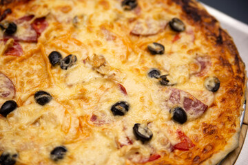 Pizza with olives pepper and cheese.
