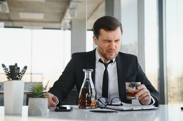 Young businessman drinking from stress