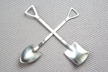 decorative fork and spoons in the form of spades on a gray background. food tools.