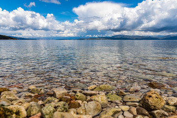 Obraz premium A beautiful landscape of the coast of the island of Corfu in the Ionian Sea of the Mediterranean in Greece. Pure blue clear water washes over the shores of the Greek island.