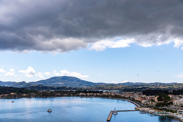 A beautiful landscape of the coast of the island of Corfu in the Ionian Sea of the Mediterranean in Greece. Pure blue clear water washes over the shores of the Greek island.