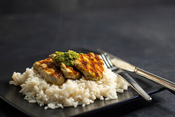 grilled poultry meat with pesto served with rice