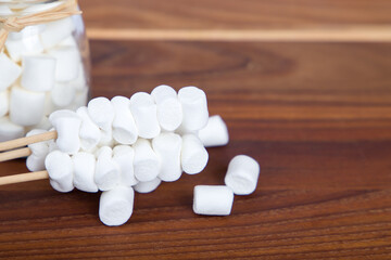 Fototapeta na wymiar white marshmallows on wooden background, copy space