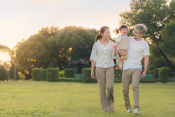 Asian father and mother walking with daughter in park, Parents hold the baby's , Happy family in...