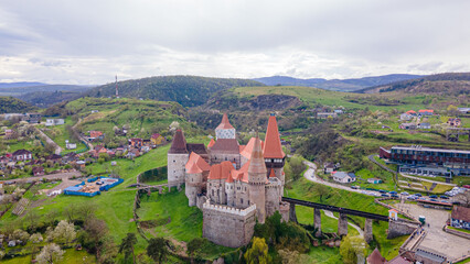 Aerial view of the Huniyad castle in Hunedoara, Romania in spring season, on a rainy day. Photography was shot from a drone at a lower altitude with the castle in the view. 