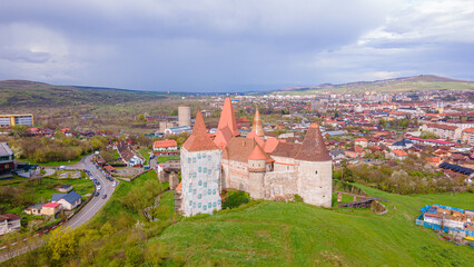 Aerial view of the Huniyad castle in Hunedoara, Romania in spring season, on a rainy day....