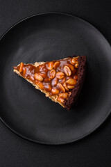 Delicious fresh cheesecake cake or snickers with cream and nuts