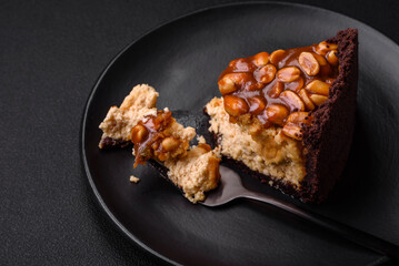 Delicious fresh cheesecake cake or snickers with cream and nuts