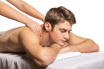 Man on a massage table is massaged by female hands