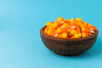 Halloween candy on a bright blue background. corn and pumpkin coffees, marmalade.Halloween holiday background with jack o lantern pumpkin, candy corn and decorations.Top view.Flat lay. Place for text.