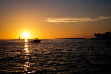 Naklejka na ściany i meble sunset over the sea with boat