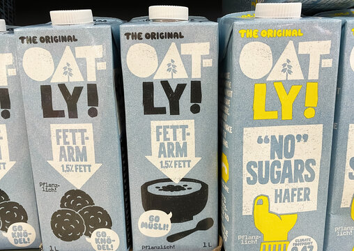 Viersen, Germany - March 9. 2023: Closeup of bags swedish oatly oat beverage in shelf of german store