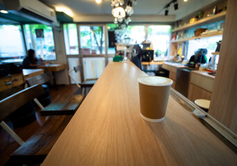 One Coffee cup paper placed on a wooden table, in a cafe coffee shop drinks are available. Hot inside for takeaway ready to drink, refreshing. aroma awake fresh to work placed