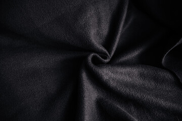The texture of dense fabric is black gabardine.
