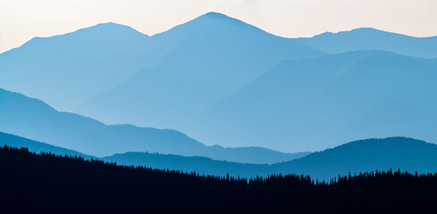 Layered mountain panoramic in blue monochromatic tones 