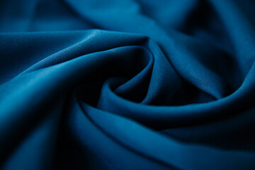 Texture of dense fabric blue gabardine. Textile drapery satin