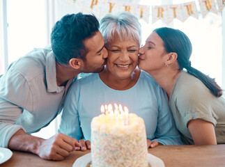 We love you. Shot of two young adults celebrating a birthday with a mature woman at home. - Powered by Adobe