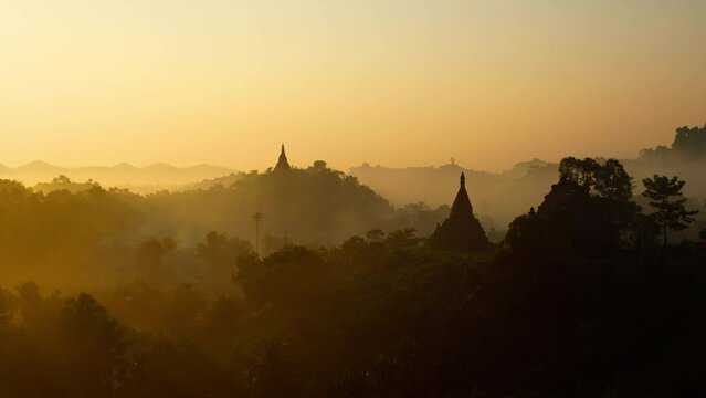 Time Lapse of morning fog and smoke moving past ancient temples in Myanmar