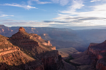 Panoramic aerial view from Bright Angel hiking trail at South Rim of Grand Canyon National Park, Arizona, USA. Vista after sunrise in summer. Colorado River weaving through valleys and rugged terrain
