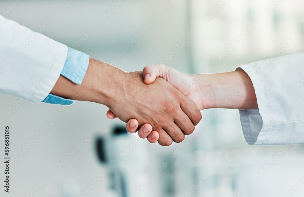 Poster Lets advance together. Closeups shot of two unrecognisable scientists shaking hands in a lab.