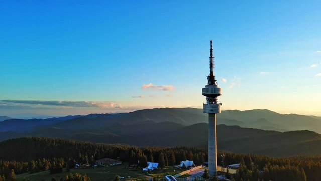 Tower Snezhana on peak of Snezhana covered with spruce forests in Rhodope mountains