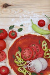 Raw pizza, tomatoes, onions, chili pepper, basil leaves, tomato paste, cooking, background image, background, photo, wallpaper for presentations