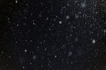 falling snow blurred background, snowflakes against the sky, snowfall in winter