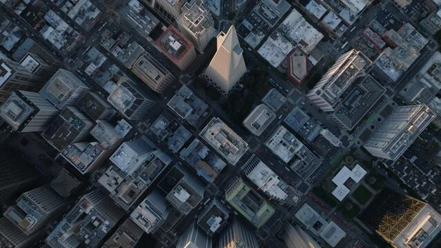 Top down panning footage of town development. Fly above Transamerica Pyramid and surrounding streets and buildings.