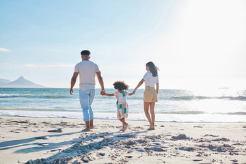 Shes leading the way. Full length shot of an affectionate young family of three taking a walk on the beach.