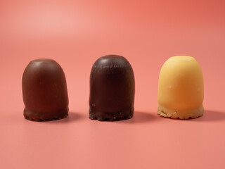 Chocolate covered marshmallow on a pink background. Close-Up.