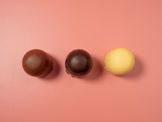 Chocolate covered marshmallow on a pink background. Close-Up.