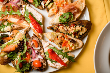 Plate with snacks. Healthy mix of seafood, vegetables, salad and creamcheese