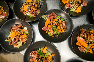 Tasty and healthy salad with jamon, salad mix, cheese, nuts and terijaki sause . Diet lunch concept.