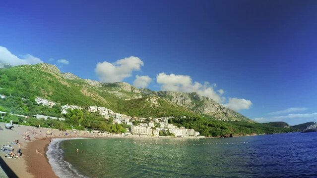 SVETI STEFAN, MONTENEGRO - SEPTEMBER 18, 2021: Scenic view on hills, Adriatic sea and Milocer beach in Sveti Stefan, Montenegro - 4K, Ultra-wide, Pan