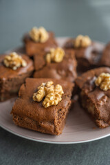 Oatmeal cake with bananas and walnuts on a dark grey background in home kitchen
