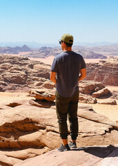Young Man Enjoying The View Of Wadi Rum Desert Landscape, Jordan