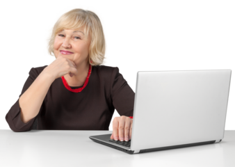 Friendly Old Woman Sitting behind Table and Using Laptop - Isolated