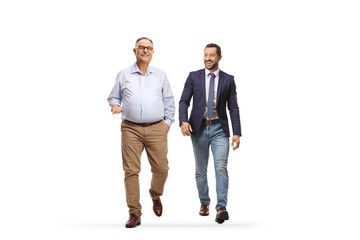 Younger and older man walking and smiling