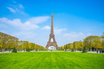 Eiffel Tower on sunny spring day. View from green lawn on Champs de Mars. Paris, France