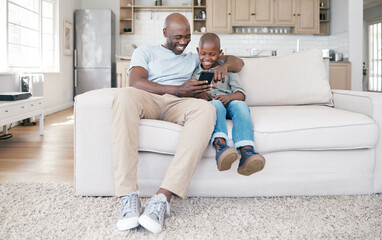 We as parents are their most important role models. Shot of a father and son using a cellphone on...