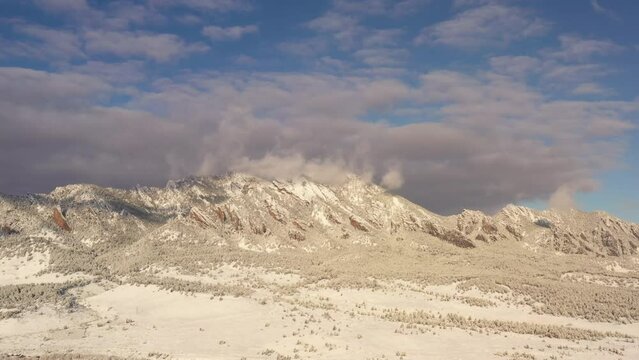 Aerial shot of the mountains near Boulder Colorado covered by fresh snow.
