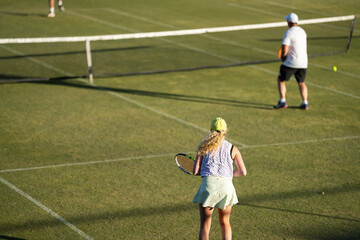 Amateur playing tennis at a tournament and match on grass in Europe 